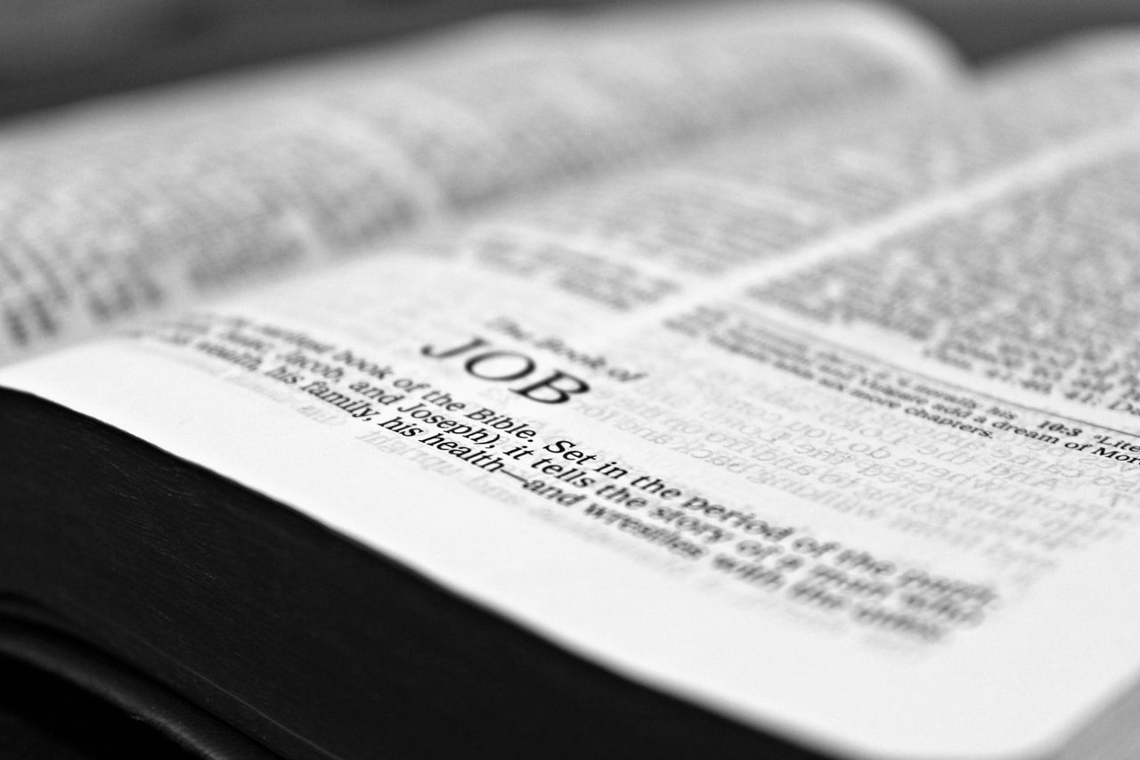 hero-gallery-03 Close-up black and white image focusing on a Bible page with the Book of Job.