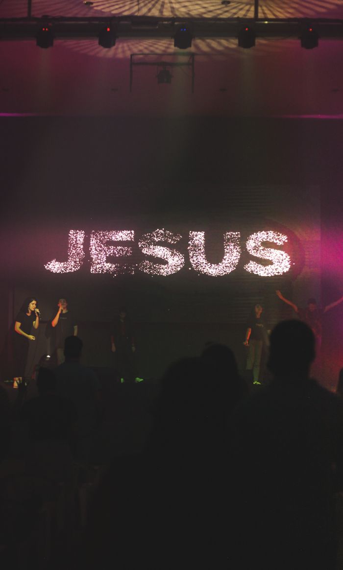 gallery-img-04 A dynamic worship music concert with a focus on Jesus, featuring live performers and vibrant lighting.